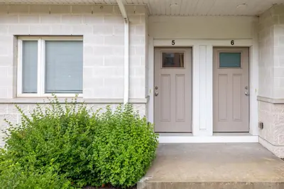 a house with two purple doors and a bush at Luxury Downtown Townhome Unit 5 in Cleveland