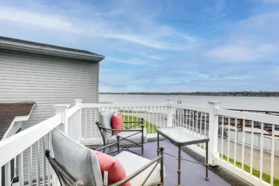 a balcony with two chairs and a table at Waterfront Buckeye Lake House Deck and Views! in Hebron