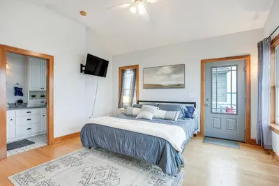 a bedroom with a large bed and a tv at Waterfront Buckeye Lake House Deck and Views! in Hebron