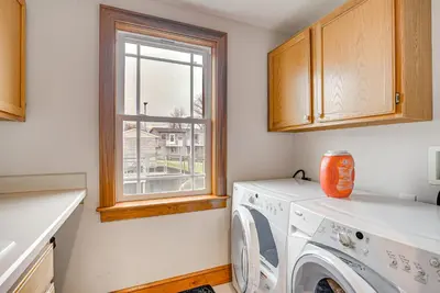 a laundry room with a washing machine and a window at Waterfront Buckeye Lake House Deck and Views! in Hebron
