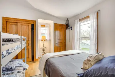 a bedroom with a bed and a window at Waterfront Buckeye Lake House Deck and Views! in Hebron