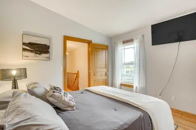 a bedroom with a bed and a television on the wall at Waterfront Buckeye Lake House Deck and Views! in Hebron