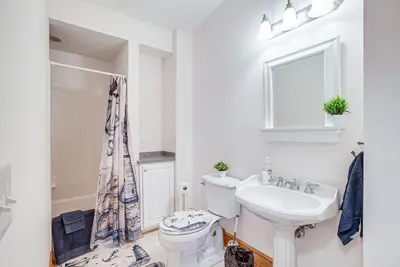 a white bathroom with a toilet and a sink at Waterfront Buckeye Lake House Deck and Views! in Hebron