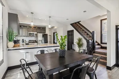 a kitchen and dining room with a table and chairs at Fairfax Urban Oasis - New Reno - 5 mins to Clinic in Cleveland