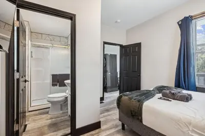 a bedroom with a bed and a bathroom with a toilet at Fairfax Urban Oasis - New Reno - 5 mins to Clinic in Cleveland