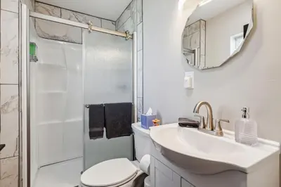 a bathroom with a sink and a toilet and a shower at Fairfax Urban Oasis - New Reno - 5 mins to Clinic in Cleveland