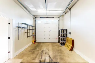 a garage with white walls and white doors at Downtown Delight with Patio! 1 Mi to Ball State in Muncie