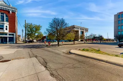 an empty street in a city with a building at Downtown Delight with Patio! 1 Mi to Ball State in Muncie