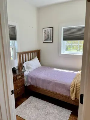 a bedroom with a bed and a window at A Winfield Bungalow in Dover