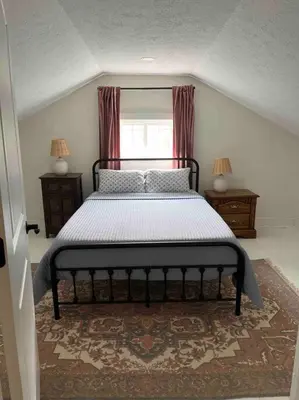 a bedroom with a bed and a window at A Winfield Bungalow in Dover