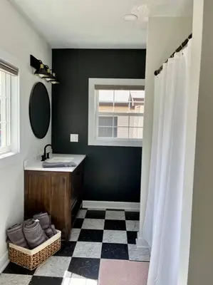 a bathroom with a sink and a mirror at A Winfield Bungalow in Dover