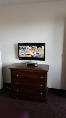 a flat screen tv sitting on top of a dresser at Hoosier Inn- Portland in Portland