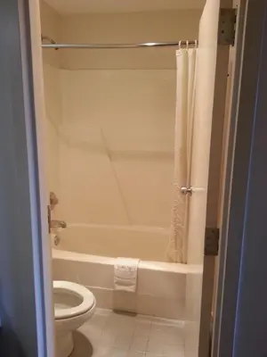 a bathroom with a white tub and a toilet at Hoosier Inn- Portland in Portland