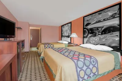 a hotel room with two beds and a flat screen tv at Super 8 by Wyndham Shelbyville in Shelbyville