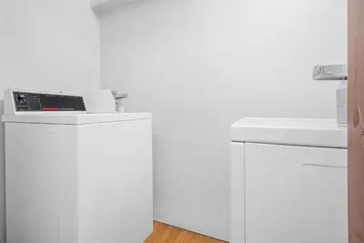 a white kitchen with a refrigerator and a sink at Super 8 by Wyndham Shelbyville in Shelbyville