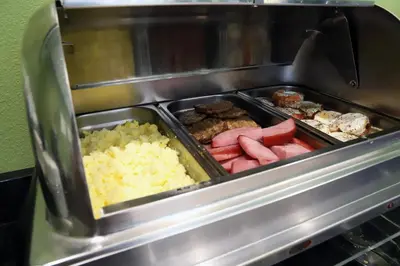 a grill with a tray of different types of food at Sleep Inn & Suites Belmont - St. Clairsville in Belmont