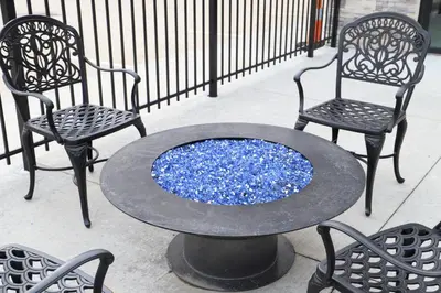 a table with two chairs and a table with blue rocks at Sleep Inn & Suites Belmont - St. Clairsville in Belmont
