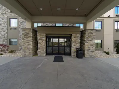 a front door of a building with a trash can at Sleep Inn & Suites Belmont - St. Clairsville in Belmont