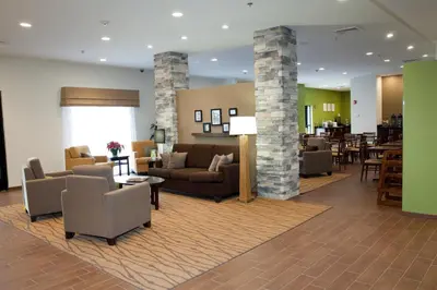 a lobby of a hotel with couches and chairs at Sleep Inn & Suites Belmont - St. Clairsville in Belmont