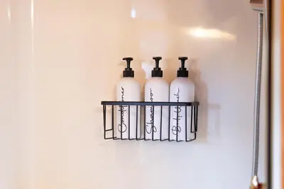 four wine bottles on a shelf on a wall at Sage Brush Cabin in Millersburg