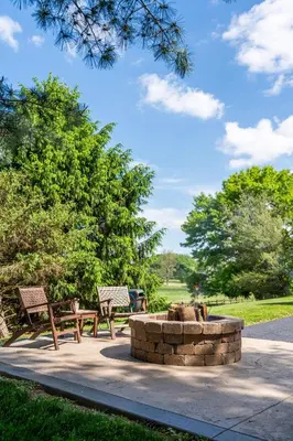 two benches and a fire pit in a park at Sage Brush Cabin in Millersburg