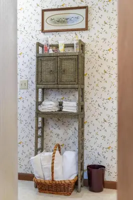 a shelf with towels and a basket in a room at Sunset Cottage in Good Hope