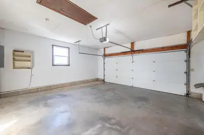 an empty garage with white walls and a window at Sunset Cottage in Good Hope