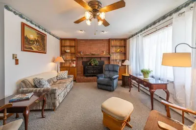 a living room with a couch and a fireplace at Sunset Cottage in Good Hope