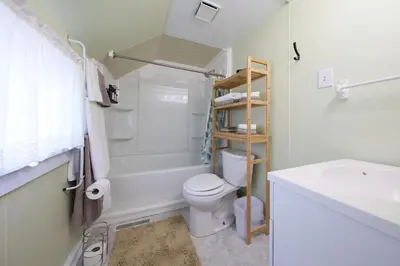 a white bathroom with a toilet and a sink at Wayfarer Inn in Dalton