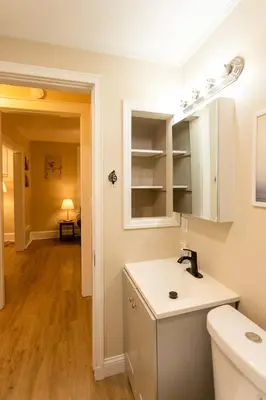 a white kitchen with a sink and a toilet at Rolston 1 Bedroom House near Xavier, Downtown in Bellevue