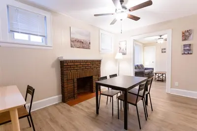 a living room with a table and a fireplace at Rolston 1 Bedroom House near Xavier, Downtown in Bellevue