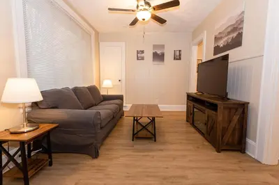 a living room with a couch and a flat screen tv at Rolston 1 Bedroom House near Xavier, Downtown in Bellevue
