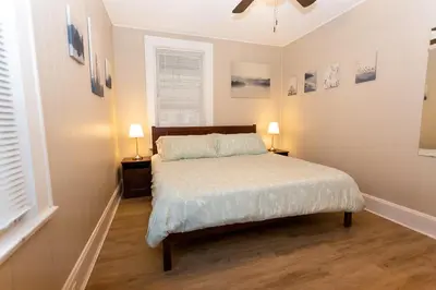 a bedroom with a bed and two lamps and two windows at Rolston 1 Bedroom House near Xavier, Downtown in Bellevue