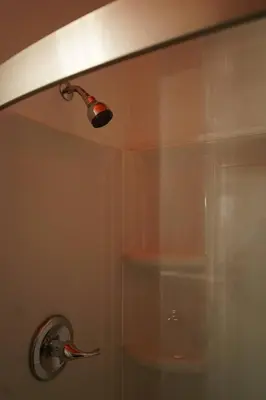 a shower in a bathroom with a light on the ceiling at Cute Charming Vintage Townhome in German Village in Columbus