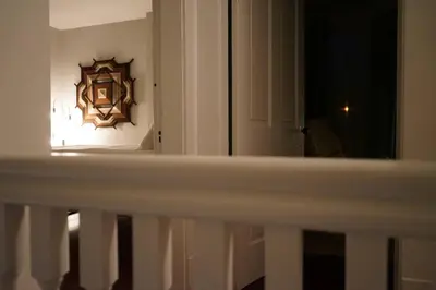 a view of a room with a mirror and a door at Cute Charming Vintage Townhome in German Village in Columbus