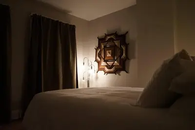 a bedroom with a bed and a mirror on the wall at Cute Charming Vintage Townhome in German Village in Columbus