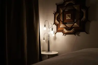 a room with a bed and a lamp and a mirror at Cute Charming Vintage Townhome in German Village in Columbus