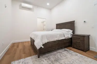 a bedroom with a large bed and a dresser at American Hall in Millersburg