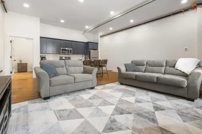 a living room with two couches and a kitchen at American Hall in Millersburg