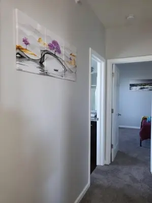a white room with a painting on the wall at Luxury 1BR/1BA w/ Top Amenities in Prime Location in Fort Wayne