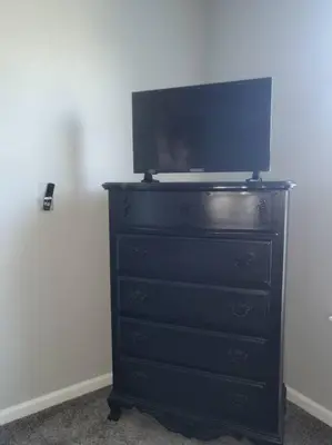 a black dresser with a tv on top of it at Luxury 1BR/1BA w/ Top Amenities in Prime Location in Fort Wayne
