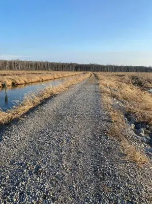 a dirt road in the middle of a field at Luxury 1BR/1BA w/ Top Amenities in Prime Location in Fort Wayne