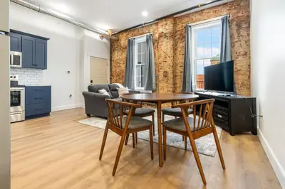a kitchen and living room with a table and chairs at Young Suite in Millersburg