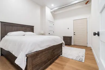 a bedroom with a large bed with a wooden headboard at Young Suite in Millersburg