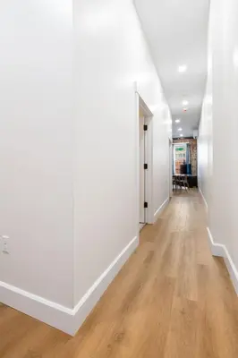 an empty hallway with white walls and wood floors at Young Suite in Millersburg