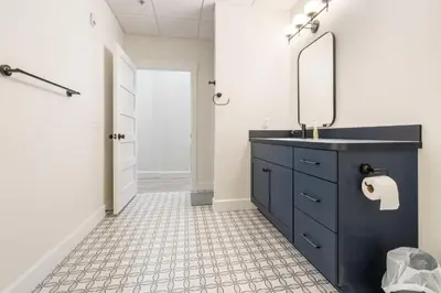 a bathroom with a blue sink and a mirror at Young Suite in Millersburg