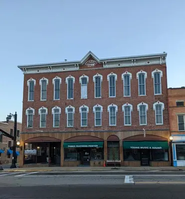 a large brick building on the corner of a street at Young Suite in Millersburg
