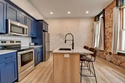 a kitchen with blue cabinets and a counter with a sink at Kaufman Suite- BY BUSY INTERSECTION in Millersburg