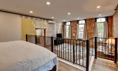 a bedroom with a bed and a balcony at Kaufman Suite- BY BUSY INTERSECTION in Millersburg
