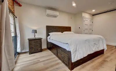 a bedroom with a large bed and a dresser and a window at Kaufman Suite- BY BUSY INTERSECTION in Millersburg